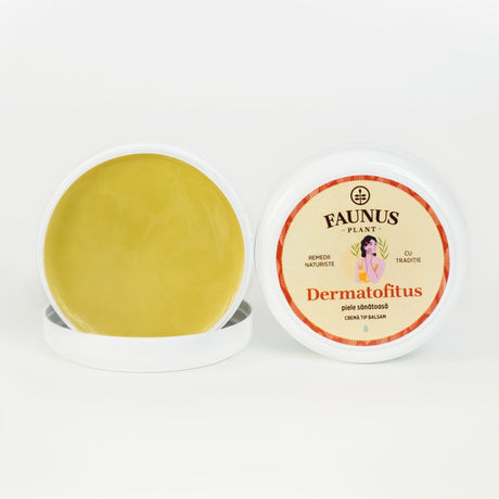 Cutie deschisă a unguentului Dermatofitus 100ml de la Faunus Plant, care expune textura unguentului, de culoare galbenă, și capacul cu eticheta ilustrată. Pe etichetă apare logo-ul Faunus Plant, denumirea produsului „Dermatofitus – Piele sănătoasă” și specificația „Cremă tip balsam”. | Cantitate - 100ml